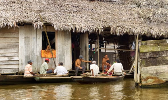 IQUITOS, PERU - MARCH 17: Group of men on canoes in the Belen neighborhood in Iquitos, Peru