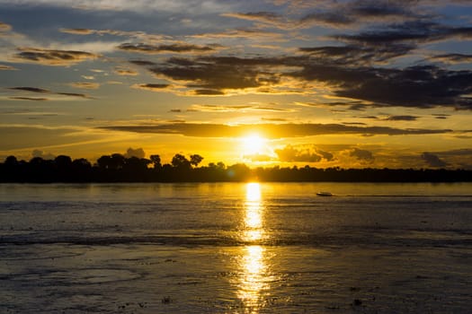 Boat on the Amazon River at sunset near Leticia, Colombia