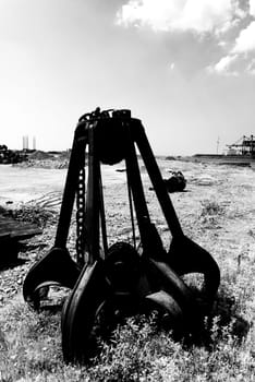 left behind rusty iron stone grabber