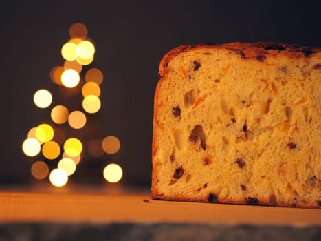 Half of a Panettone with a Christmas tree in background