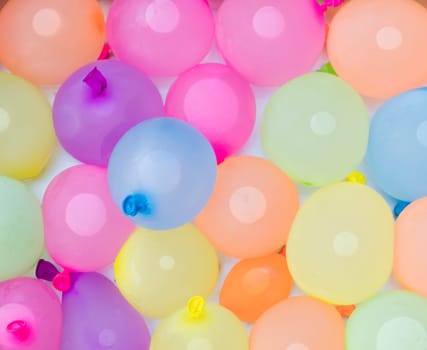 background of colorful water balloons ready for action on a hot summer day