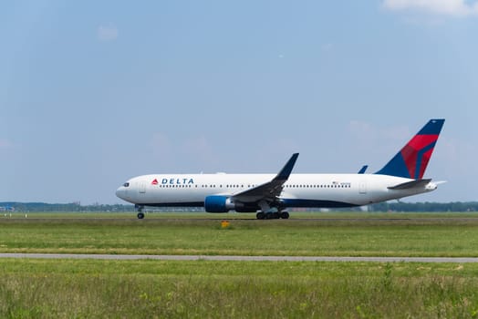 SCHIPHOL, NETHERLANDS - JUNE 4, 2016: Delta airlines plane takes off at amsterdam international airport