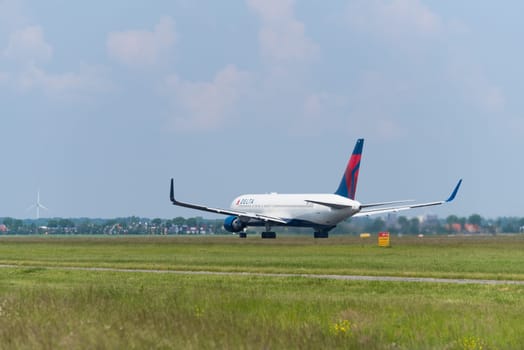 SCHIPHOL, NETHERLANDS - JUNE 4, 2016: Delta airlines plane takes off at amsterdam international airport