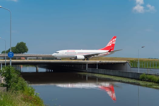 SCHIPHOL, NETHERLANDS - JUNE 4, 2016: Georgian airways Airzena airplane taxiing to the runway on amsterdam schiphol airport
