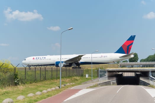 SCHIPHOL, NETHERLANDS - JUNE 4, 2016: Delta airlines plane taxiing to the runway on schiphol airport