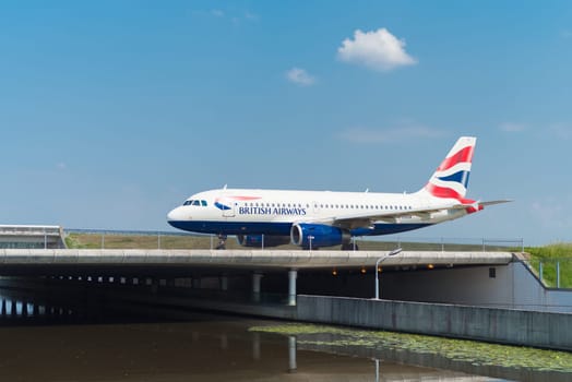 SCHIPHOL, NETHERLANDS - JUNE 4, 2016: British airways airplane taxiing to the runway on amsterdam schiphol airport