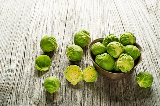 Fresh raw brussels sprouts on a wooden background
