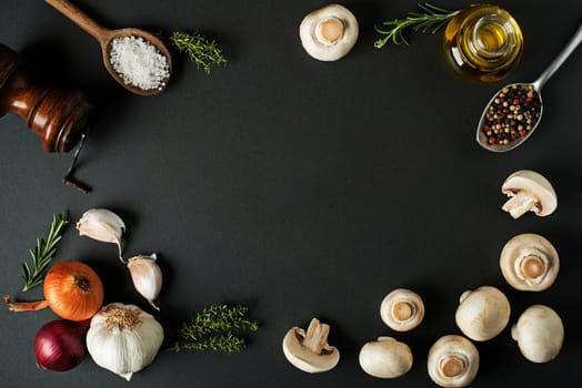 Mushrooms champignons with fresh ingredients on wooden background