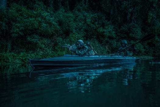 Special forces men with painted faces in camouflage uniforms paddling army kayak. Boat moving calmly across the river, diversionary mission, twilight