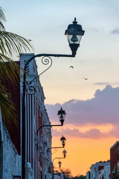 View of street lights and a colorful sunset in Valladolid, Mexico