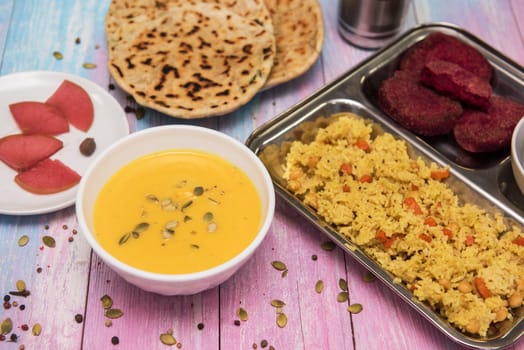 Vegetarian food: pea soup, pilaf, flat cakes, beet cutlets, pumpkin seeds and compote of pickled pears