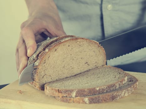 Close up shot of a man cutting bread