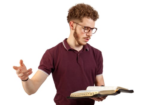Young man reading from the Bible on white background
