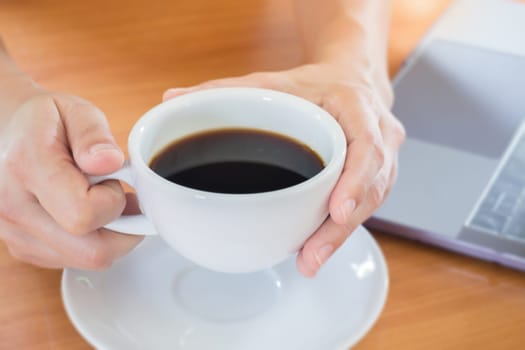 Hand On Hot Cup Of Coffee, stock photo