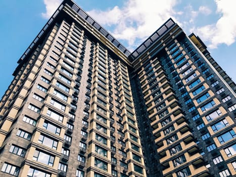 Top part of high-rise business building on blue sky