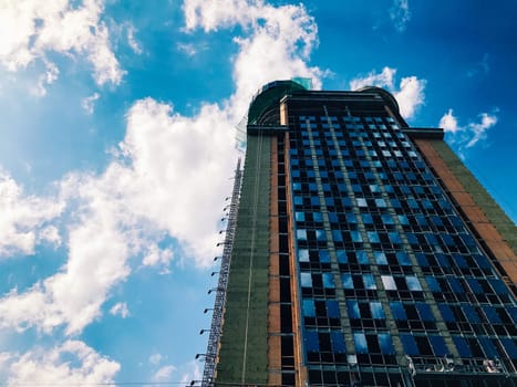 Top part of high-rise business building on blue sky