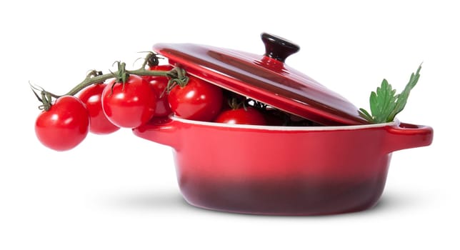 Cherry tomatoes and parsley in saucepan with lid isolated on white background