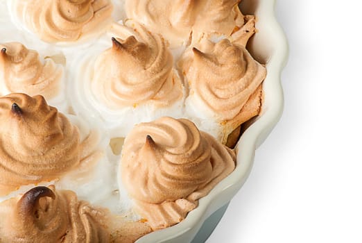 Closeup lemon pie with meringue on dish isolated on white background