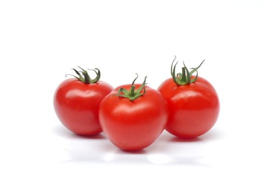 Red ripe tomatoes are on white background.
