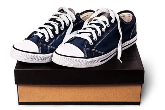 Dark blue sports shoes on the cardboard box isolated on white background