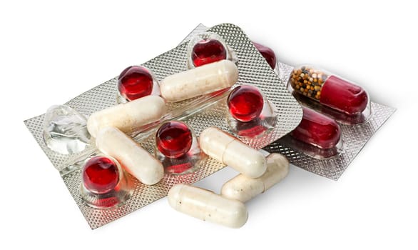 Heap of pills and capsules in package isolated on white background