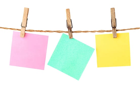 Multicolored paper stickers on clothespins isolated on white background
