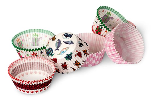 Multicolored paper cups for baking muffins isolated on white background