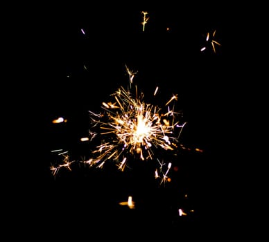Single bright festive New Year Christmas sparkler on black background