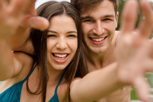 Portrait of a young couple embraced inside the pool