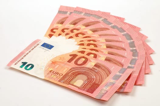 Euro banknotes of ten euro are on white background.