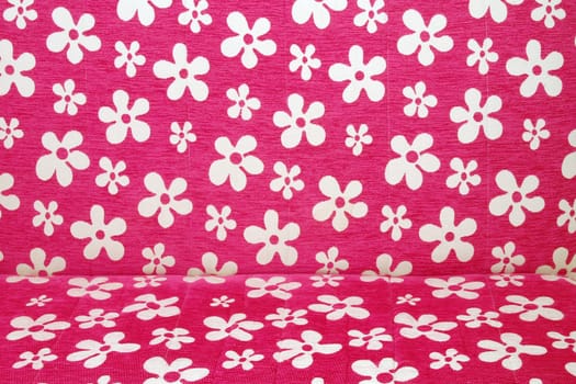 Pink cauch with white flowers as background.