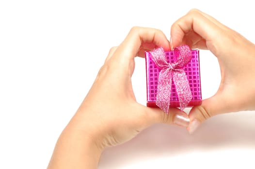 The little pink gift box is in heart shape from hands.