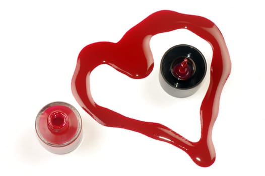 Heart shape from red nail polish on white background.