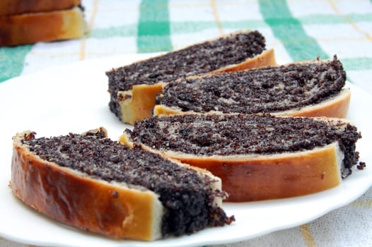 Poppy seed cakes are on plate.