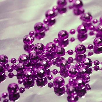 The purple necklace is on gray background.