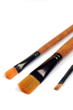 Three paint brushes are on the white background.