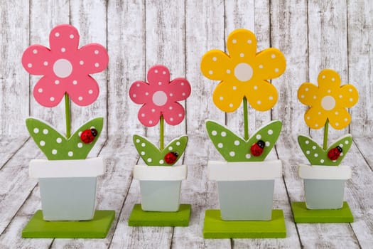 Decorative wooden flowers on background with structure