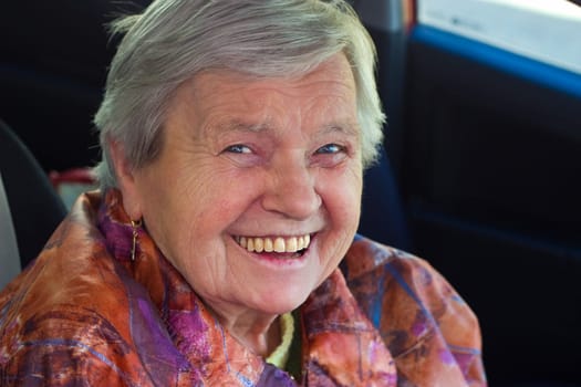 Cheerful senior citizen looks into the camera
