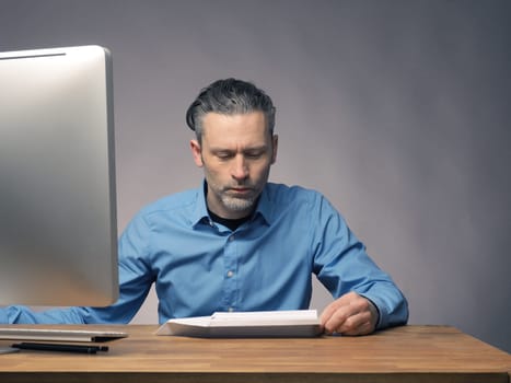 Handsome businessman with a paper plane, start up or upswing concept