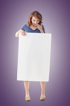 Excited Asian girl hold a blank board, full length portrait isolated.