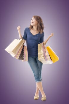 Cheerful shopping woman of Asian holding bags, isolated.
