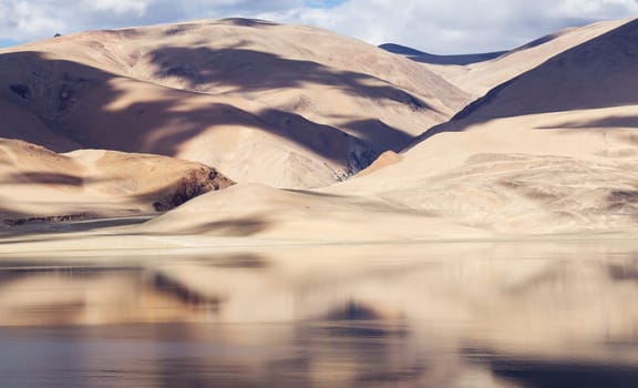 Tso Moriri mountain lake panorama with mountains and blue sky reflections in the lake (north India)
