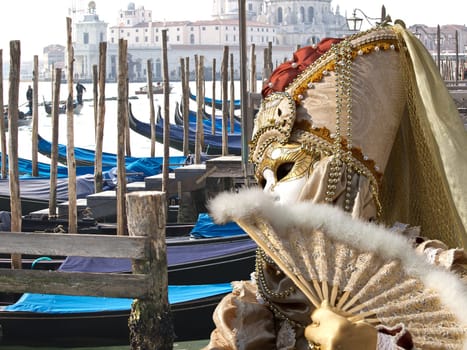 boats in the venice infont of st Marco piaza with golden mask