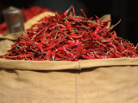 red chilly peppers in the yutta bag on the open market in Nepal