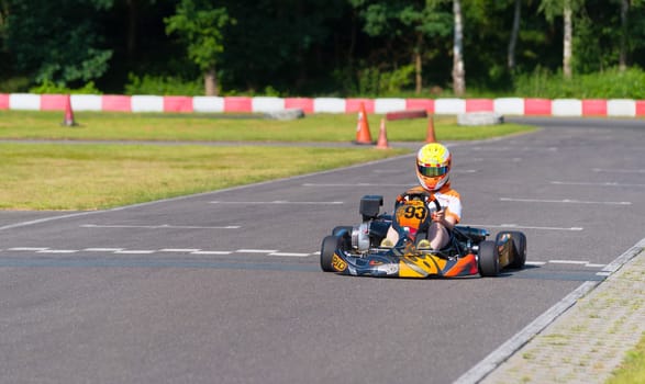 OLDENZAAL, NETHERLANDS - JUNE 7, 2016: Boy karting on an empty karting track