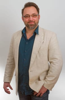 Standing man with jacket on a light background