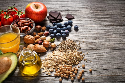 Selection of healthy food on wooden background. Healthy diet foods for heart cholesterol and diabetes