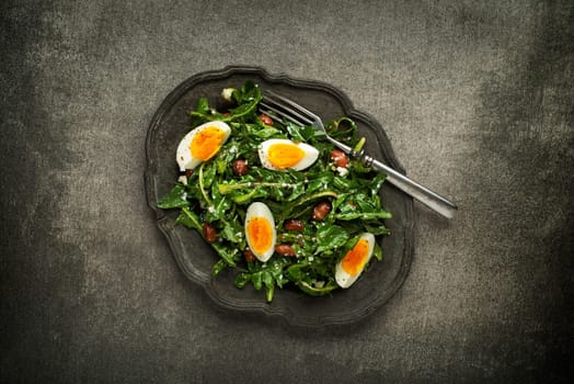 Fresh dandelion salad with eggs and beans overhead shoot