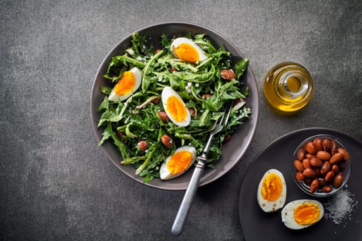 Fresh dandelion salad with eggs and beans overhead shoot