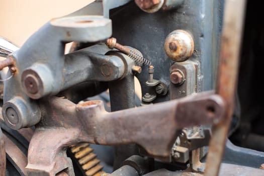 Old rusty printing machine complex mechanism of metal with close up details